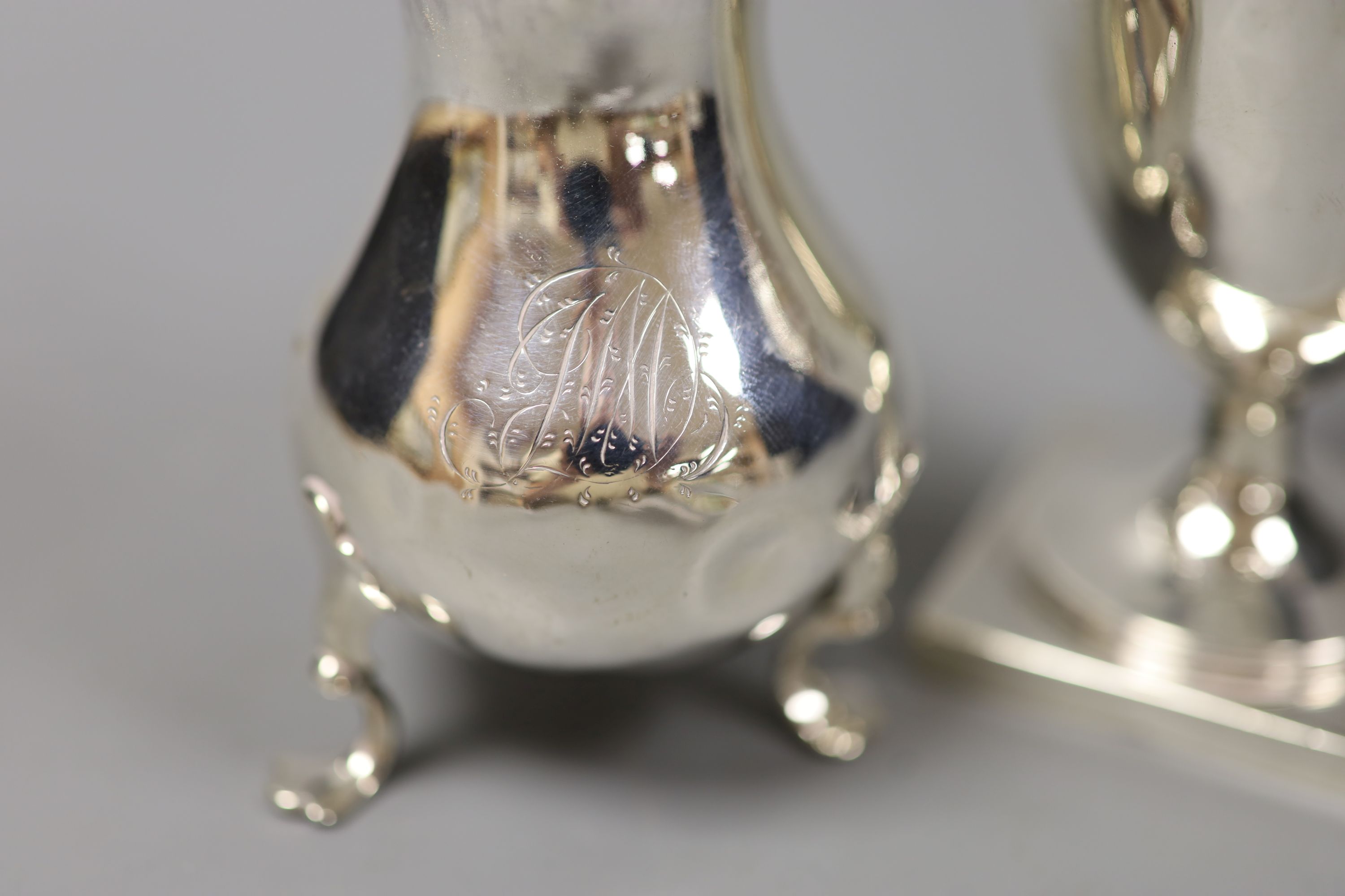 A George III silver helmet cream jug, London 1791 and another cream jug of bellied form,